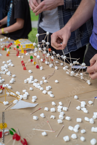 Field trip to the University of Washington Engineering days, structural engineering experiment build a bridge detail close up with hands building