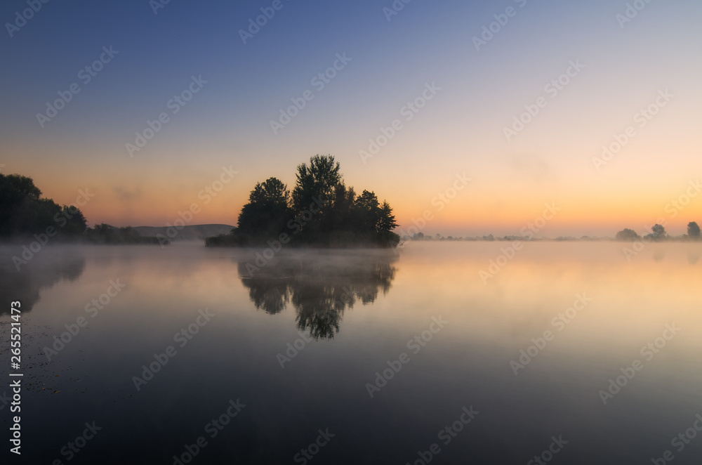 Island on the lake reflecting in the morning
