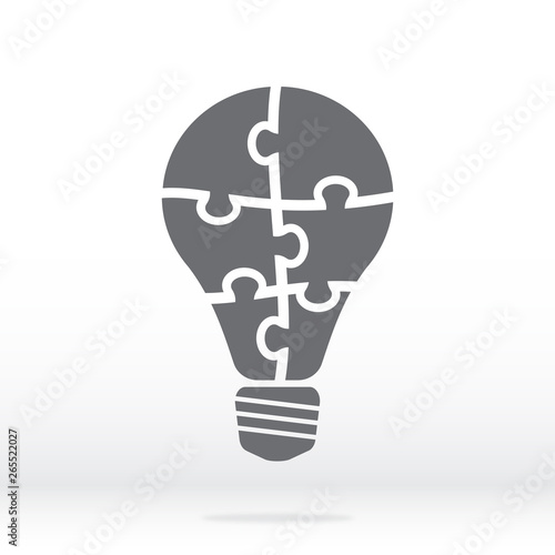 Simple icon light bulb puzzle in gray. Simple icon puzzle of the six pieces on gray background. Flat design. Vector illustration EPS10.