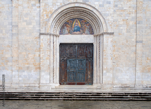 Main door of Sarzana cathedral, dedicated to the Assumption of the Virgin Mary. Beautiful artwork. In Liguria, Italy.