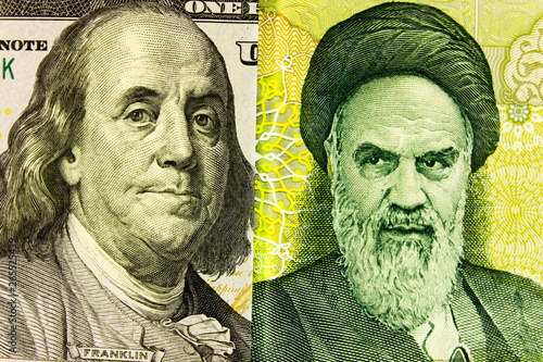 Portrait of Franklin on  banknote 100 US dollars and  Ayatollah Khomeini on Iranian rials. Concept of the exchange rate, stock exchange, internet trading. photo