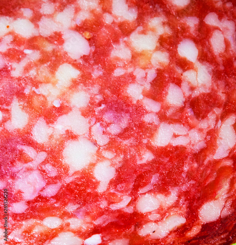 Close Up of a Salami Pepperoni Slice on Black Background Abstract View