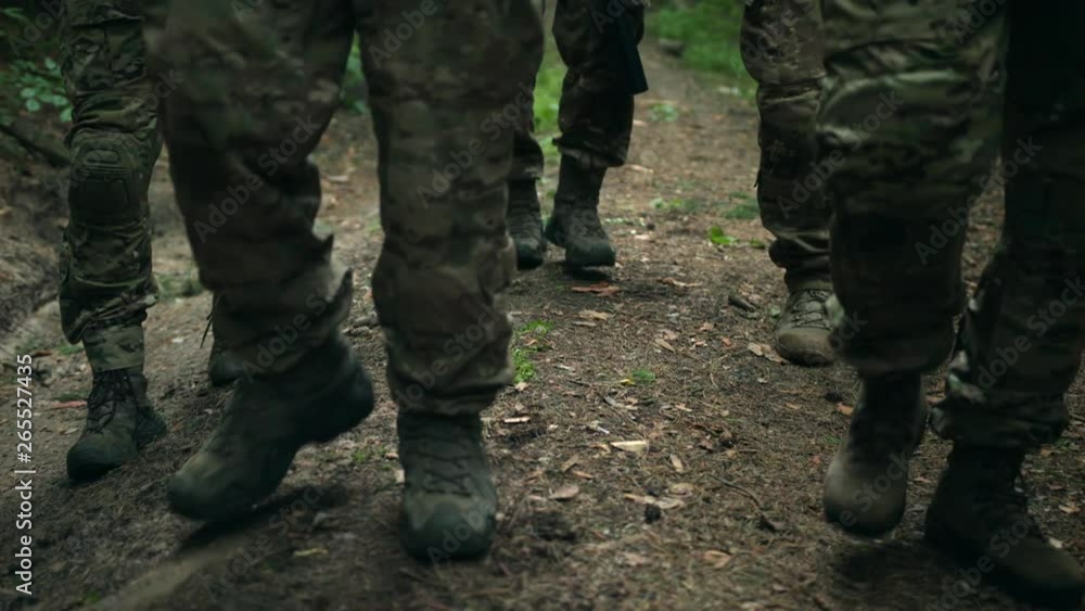 Fully Equipped Soldiers. Military Operation in Action, Squad going in Formation Through Dense Forest. Slow Motion. 4K. Fully Equipped Soldiers. Military Operation in Action, Squad going in Formation Through Dense Forest. Slow Motion. 4K.