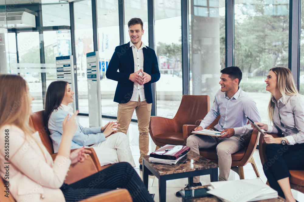 Business team working on new project and smiling. Man and women sitting together in modern office for project discussion. Business team working on new project and smiling. Man and women sitting together in modern office for project discussion.