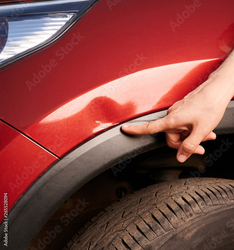 Fototapeta Finger point at car scratch