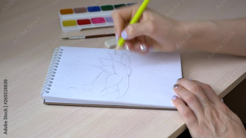 artist is working on a painting on the easel in the workshop with a pencil artist is working on a painting on the easel in the workshop with a pencil