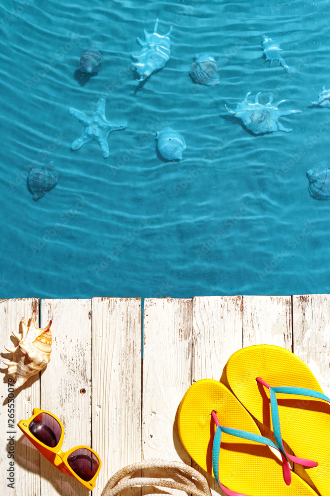 Naklejka premium Summer accessories on white wooden background. Summer mood. Top view.