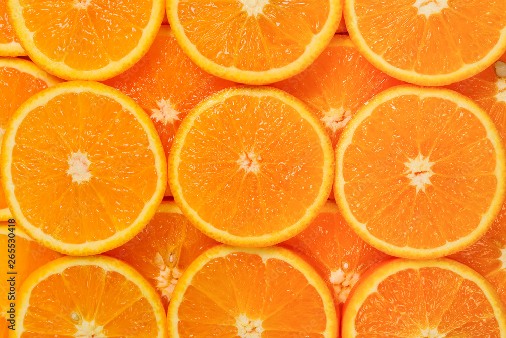 Slices of oranges as a background, top view.