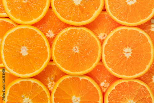 Slices of oranges as a background  top view.