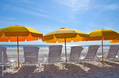 Beach Chairs Umbrellas Lounge on the Ocean Surf and Beach Sand