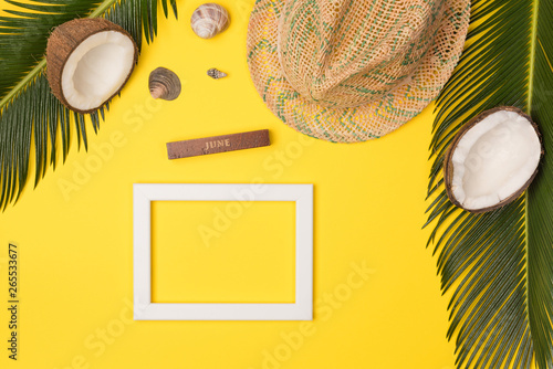 summer photo frame on yellow background, top view