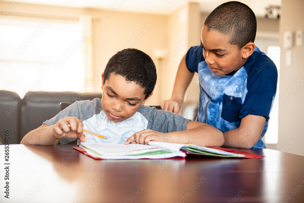 two black brother child doing homework at home two black brother child doing homework at home