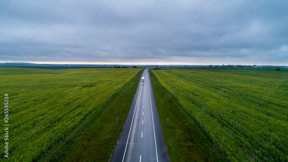 Highway between two green fields