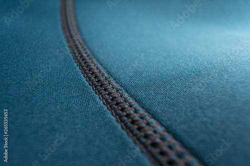 Close up of stitching along the seam of a blue neoprene scuba diving wetsuit photo