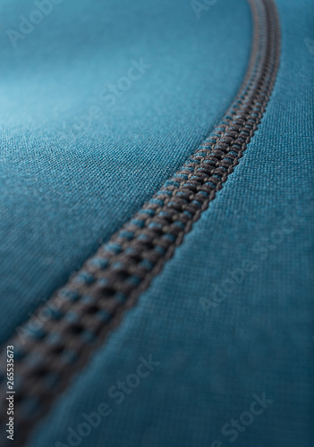 Close up of stitching along the seam of a blue neoprene surfing wetsuit photo