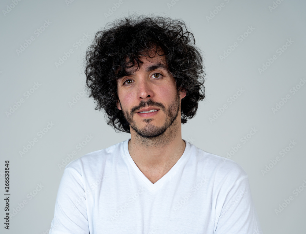 Natural portrait of young attractive man in his 20s looking and posing with neutral face expression Natural portrait of young attractive man in his 20s looking and posing with neutral face expression