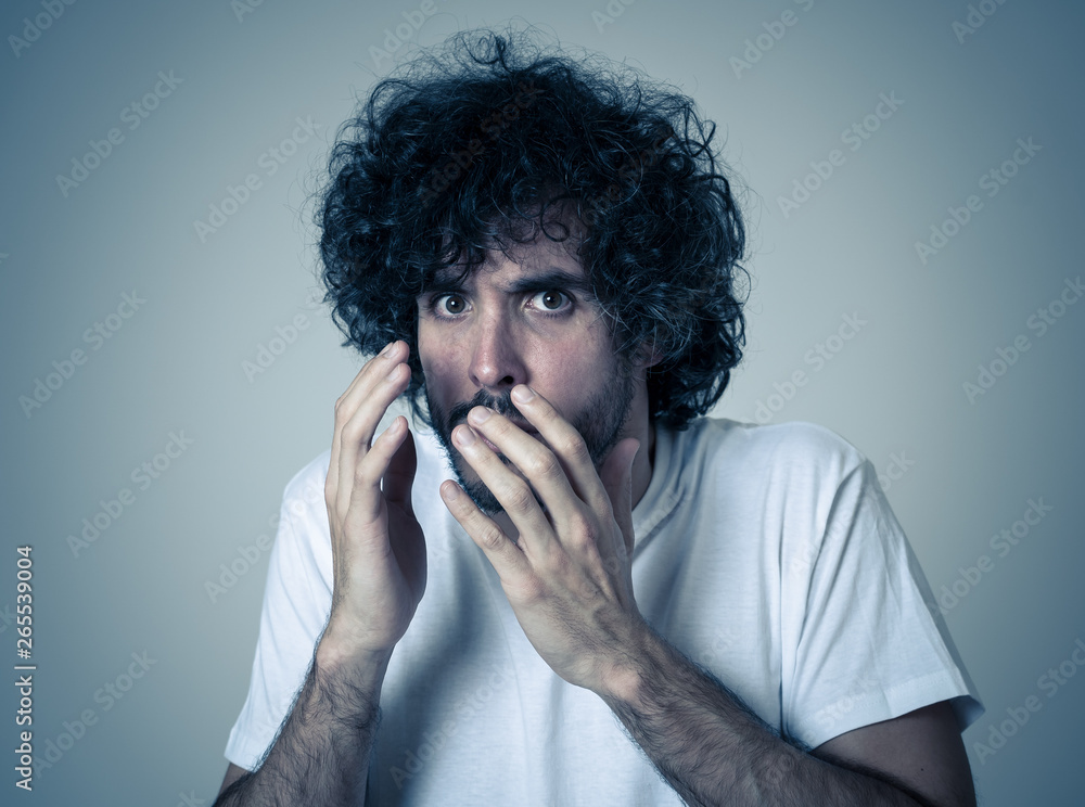Close up portrait of concern shocked young man with frightened gestures. Scared facial expression Close up portrait of concern shocked young man with frightened gestures. Scared facial expression