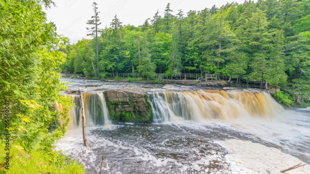 Naklejka premium Beautiful waterfall at Porcupine Mountains Wilderness State Park in the Upper Peninsula of Michigan - smooth tranquil flowing water