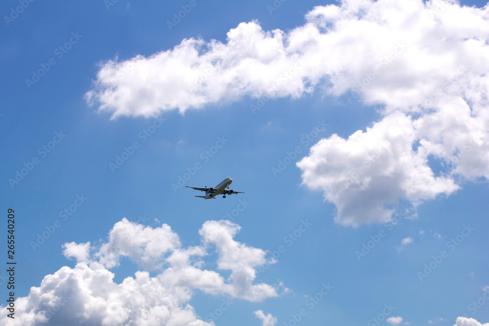 Passenger airplane in a blue sky with clouds Passenger airplane in a blue sky with clouds