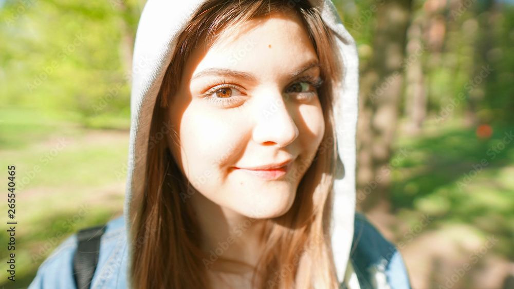 Calm beautiful smiling young woman enjoying fresh air , relaxing , feeling alive, breathing, dreaming. Copy space, green park nature background. Side view portrait Calm beautiful smiling young woman enjoying fresh air , relaxing , feeling alive, breathing, dreaming. Copy space, green park nature background. Side view portrait