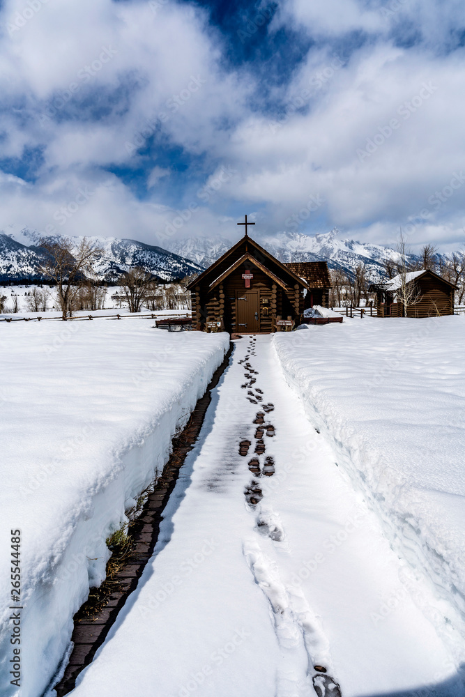 Chapel in the Snow with Mountains and Footsteps