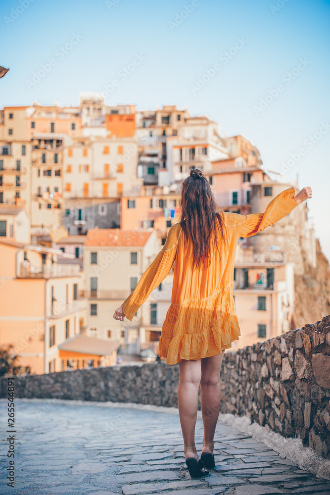 Tourist looking at scenic view of Manarola, Cinque Terre, Liguria, Italy