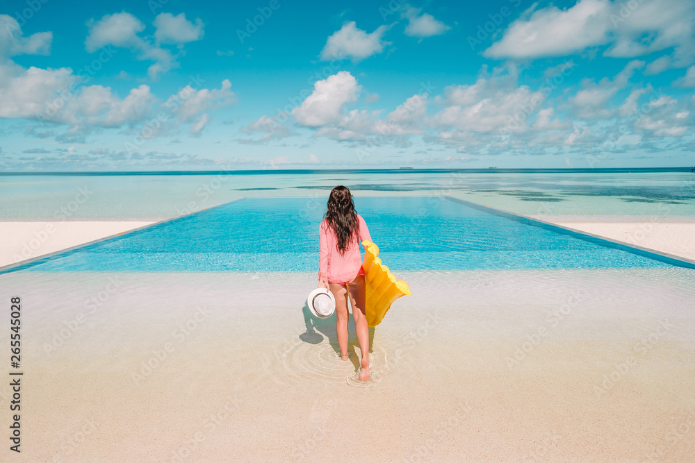 Young happy woman relaxing in a swimming pool Young happy woman relaxing in a swimming pool