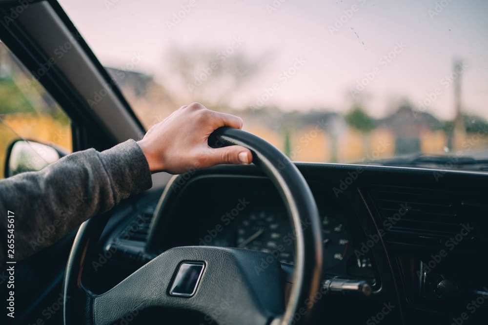 hands of the driver on the steering wheel of the car in the summer day trip hands of the driver on the steering wheel of the car in the summer day trip