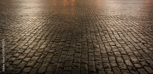 Close up of cobblestone street at night photo