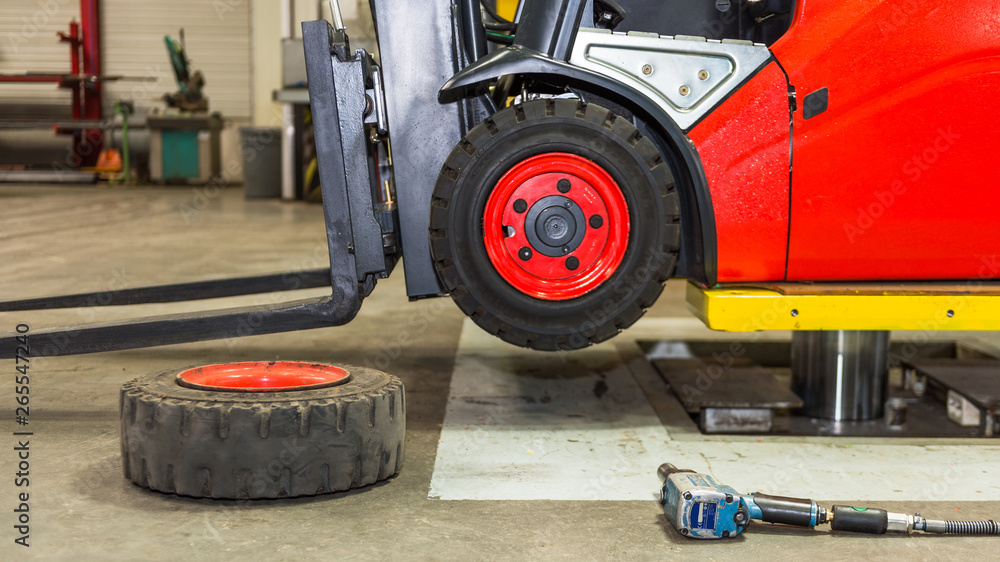 Forklift machinery on lift in garage Forklift machinery on lift in garage