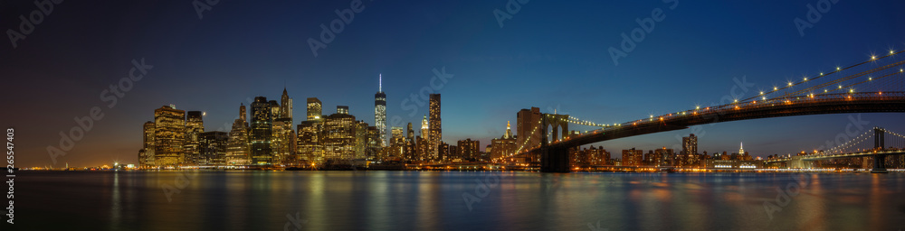 Panoramic view of New York city skyline illuminated at night, New York, United States Panoramic view of New York city skyline illuminated at night, New York, United States