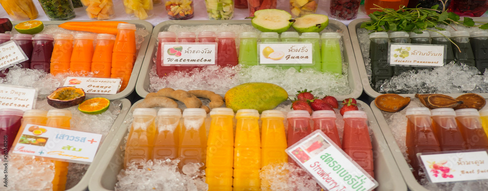 Close up of fresh juices for sale in market Close up of fresh juices for sale in market