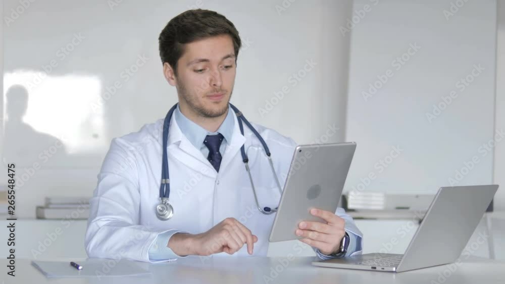 Young Doctor Talking with Patient via Video Chat on Tablet Young Doctor Talking with Patient via Video Chat on Tablet