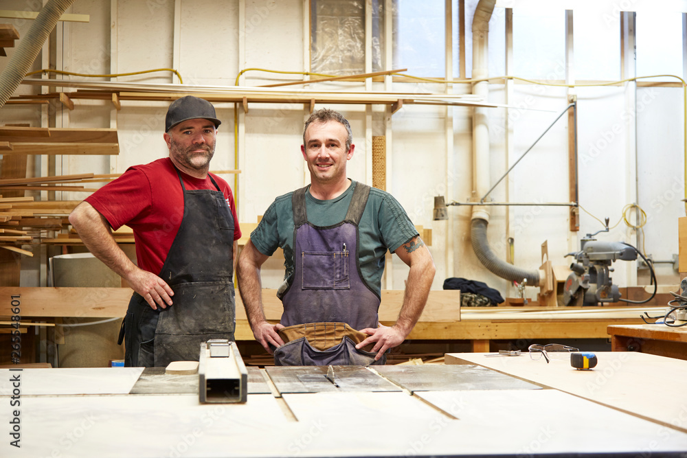 Carpenters smiling in workshop Carpenters smiling in workshop