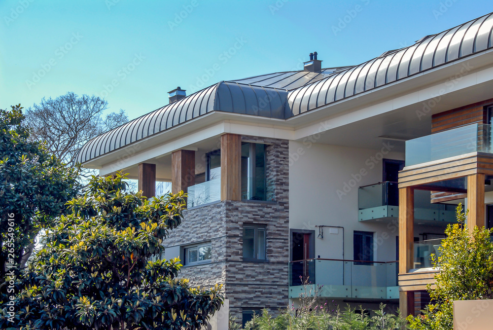 Istanbul, Turkey, 22 March 2015: Beautiful exterior of newly built luxury home. Yard with green grass. Istanbul, Turkey, 22 March 2015: Beautiful exterior of newly built luxury home. Yard with green grass.