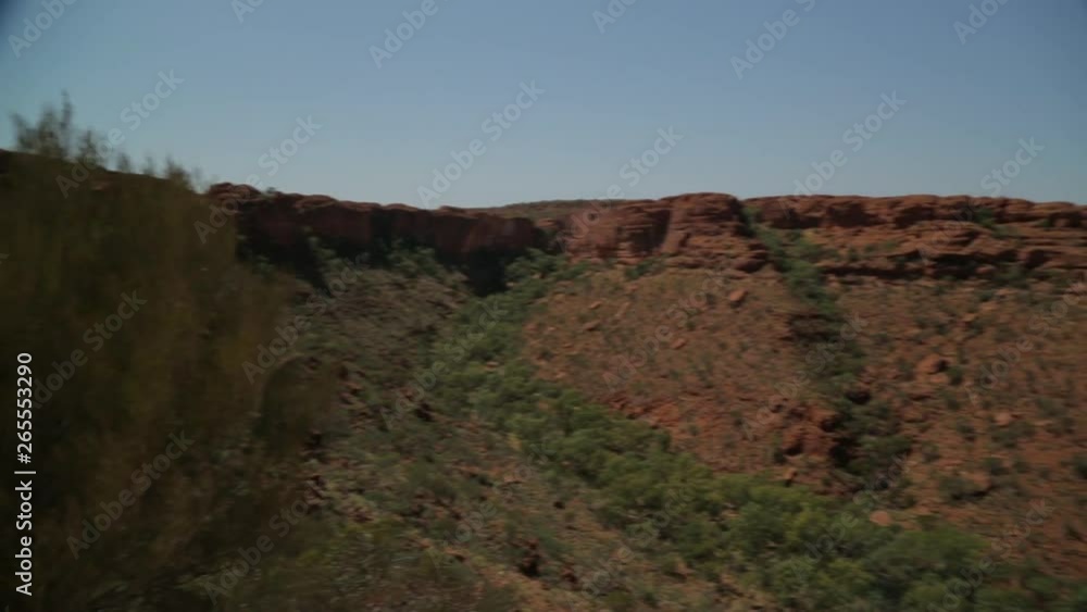 Medium panning shot of King's Canyon sandstones, and desert's shrubs, Watarrka National Park, Central Australia Medium panning shot of King's Canyon sandstones, and desert's shrubs, Watarrka National Park, Central Australia