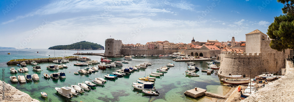 Obraz premium Mediterranean panorama of the beautiful Dubrovnik old city including the old port, city walls and fortifications.