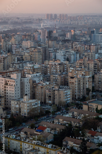 Aerial view of a residential neighborhood in a city during a vibrant and colorful sunrise. Taken in Netanya  Center District  Israel.