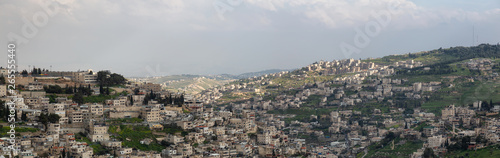Aerial panoramic cityscape view of Jabal Batin alHawa residential neighborhood during a cloudy day. Taken in Jerusalem, Israel.