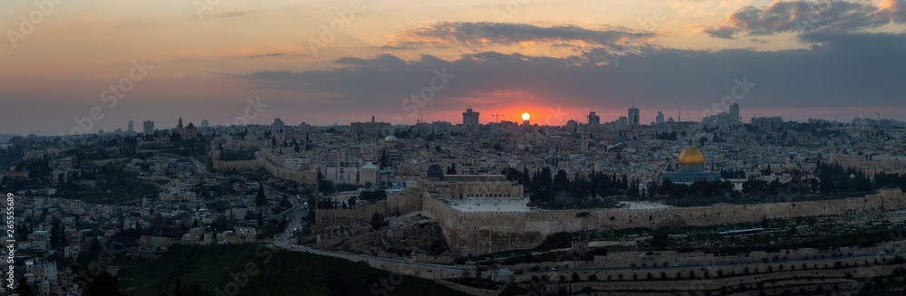 Beautiful panoramic aerial view of the Old City and Dome of the Rock during a dramatic colorful sunset. Taken in Jerusalem, Capital of Israel.