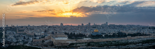 Beautiful panoramic aerial view of the Old City and Dome of the Rock during a dramatic colorful sunset. Taken in Jerusalem, Capital of Israel.