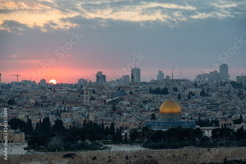 Beautiful aerial view of the Old City and Dome of the Rock during a dramatic colorful sunset. Taken in Jerusalem, Capital of Israel.