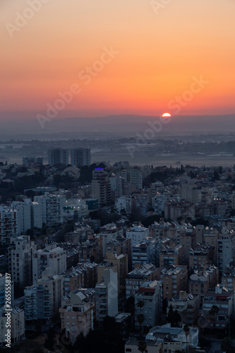 Aerial view of a residential neighborhood in a city during a vibrant and colorful sunrise. Taken in Netanya  Center District  Israel.