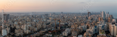 Aerial panoramic view of a residential neighborhood in a city during a vibrant and colorful sunrise. Taken in Netanya, Center District, Israel.
