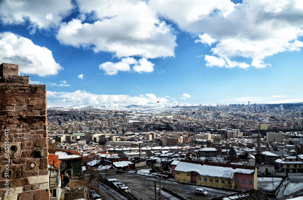 The ancient walls of Ankara Castle covered with snow in winter time, cityscape from Ankara