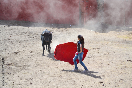 Girl Bullfighting A Bull With A Red Cape In A Ground Bullring Stock Photo Adobe Stock