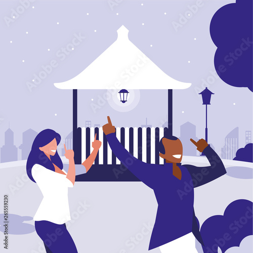 young interracial couple dancing in the park