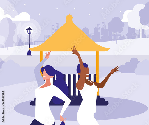 young interracial girls dancing in the park