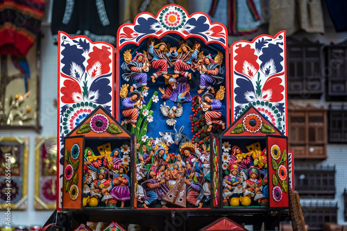 Colorful Peruvian artisanal Retablo for sale at street Indian market in Miraflores, Lima. A traditional devotional handcraft with iconography derived from traditional Catholic church art. photo