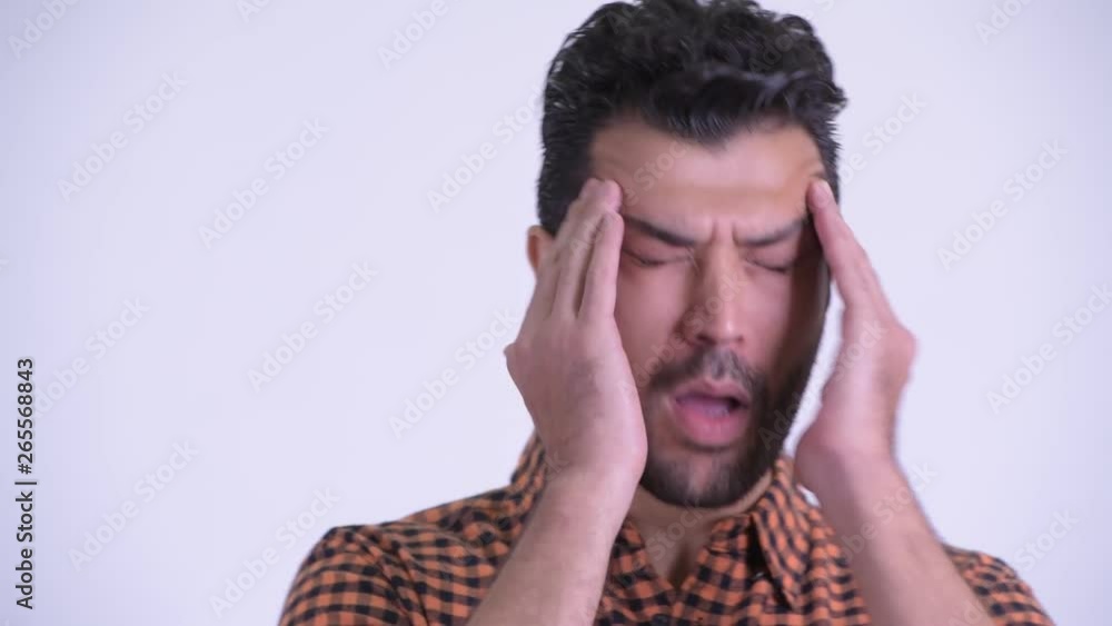 Face of stressed bearded Persian hipster man having headache Face of stressed bearded Persian hipster man having headache